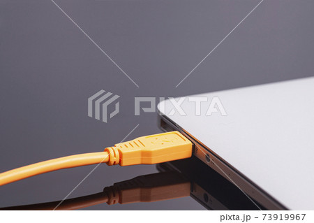 laptop with USB orange cable 73919967