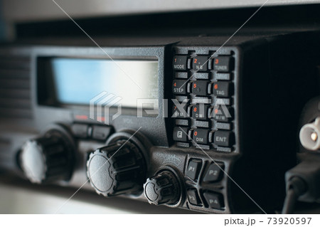 This is a close-up black portable radio station. Radio receiver with buttons and display. 73920597