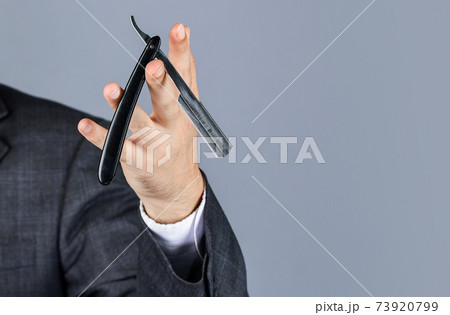 man hold retro razor blade in hand. Master grooming hair man hold retro razor blade in hand. Master grooming hair 73920799