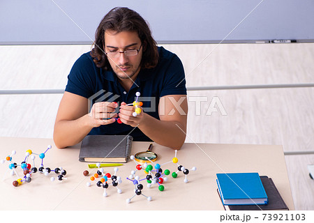 Young male scientist sitting in the classroom 73921103