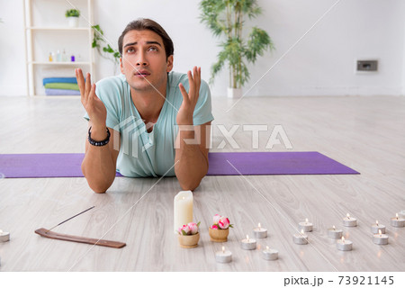 Young man during yoga session at home 73921145