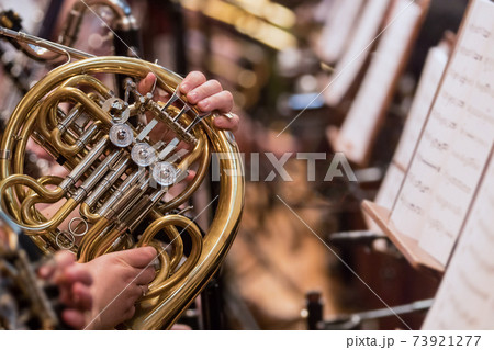 Horn professional player with symphony orchestra performing 73921277
