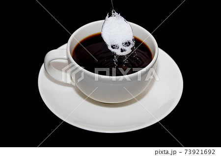 Unhealthy white sugar concept. Scull spoon with sugar and cup of black coffee Unhealthy white sugar concept. Scull spoon with sugar and cup of black coffee 73921692