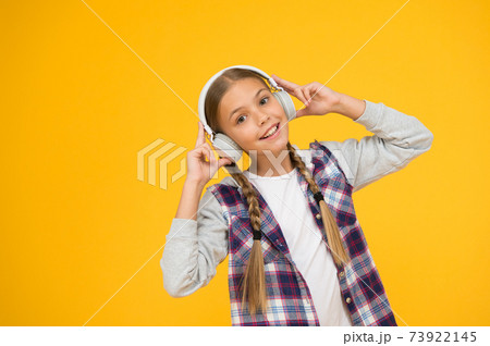 Happy little girl wearing modern headphones. Cute kid  73922145
