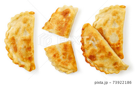 Set of fried pasties with whole and half meat on a white background, isolated cheburek. Top view Set of fried pasties with whole and half meat on a white background, isolated cheburek. Top view 73922186
