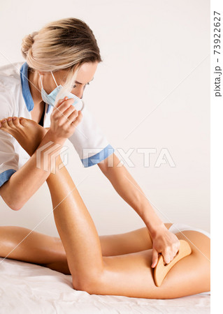 Anti-cellulite massage with wooden tool blade Anti-cellulite massage with wooden tool blade 73922627