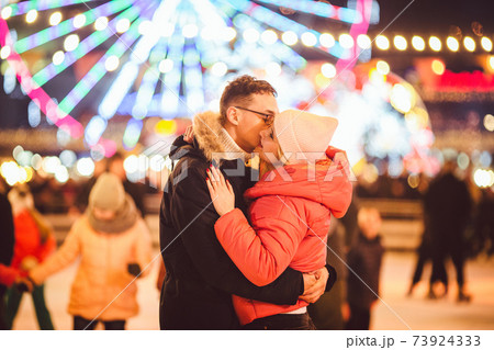 Ice skating together. Romantic winter vacation in ice arena. Young couple skating at ice rink. Best Christmas ever. Winter fun. Cute Valentine's Day. New Year with couple on skating. winter holidays 73924333