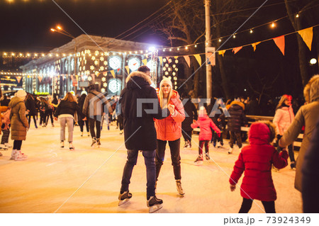 Ice skating together. Romantic winter vacation in ice arena. Young couple skating at ice rink. Best Christmas ever. Winter fun. Cute Valentine's Day. New Year with couple on skating. winter holidays Ice skating together. Romantic winter vacation in ice arena. Young couple skating at ice rink. Best Christmas ever. Winter fun. Cute Valentine's Day. New Year with couple on skating. winter holidays 73924349