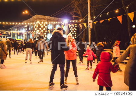Ice skating together. Romantic winter vacation in ice arena. Young couple skating at ice rink. Best Christmas ever. Winter fun. Cute Valentine's Day. New Year with couple on skating. winter holidays Ice skating together. Romantic winter vacation in ice arena. Young couple skating at ice rink. Best Christmas ever. Winter fun. Cute Valentine's Day. New Year with couple on skating. winter holidays 73924350