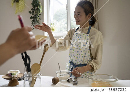 お菓子作りを教える女性 お菓子作りを教える女性 73927232