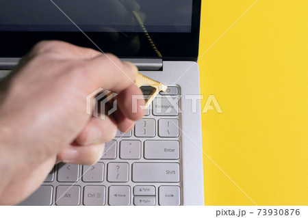 Person using contactless tool for press button to protect from contracting coronavirus infection 73930876