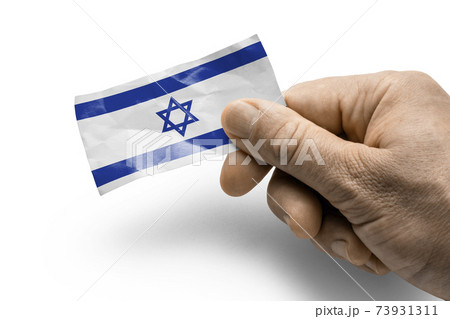 Hand holding a card with a national flag the Israel Hand holding a card with a national flag the Israel 73931311