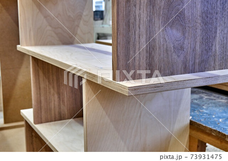 Joinery. Plywood bookshelves. Production of wood furniture. Furniture manufacture. Close-up Joinery. Plywood bookshelves. Production of wood furniture. Furniture manufacture. Close-up 73931475