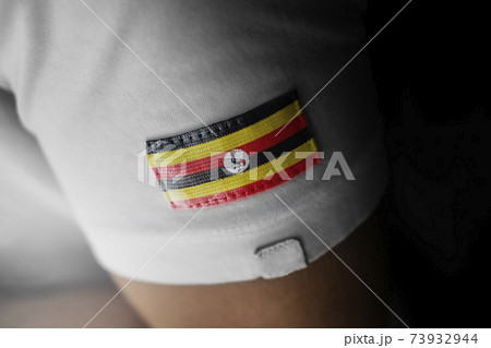 Patch of the national flag of the Uganda on a white t-shirt Patch of the national flag of the Uganda on a white t-shirt 73932944
