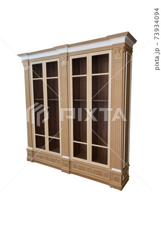 Bookcase. Mdf cabinet carcass with moldings and wooden carved capital on a white background. Work in progress Bookcase. Mdf cabinet carcass with moldings and wooden carved capital on a white background. Work in progress 73934094