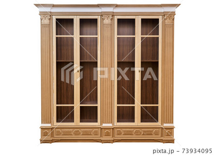 Bookcase. Mdf cabinet carcass with moldings and wooden carved capital on a white background. Work in progress Bookcase. Mdf cabinet carcass with moldings and wooden carved capital on a white background. Work in progress 73934095