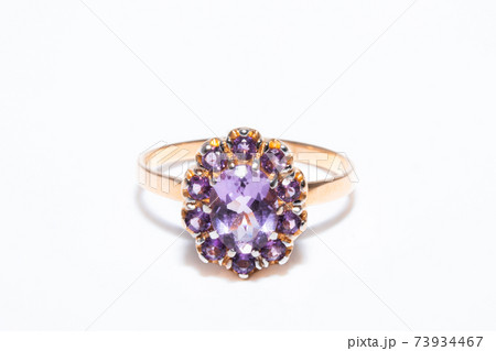 Beautiful golden ring with purple gemstone isolated on white background 73934467