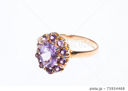 Beautiful golden ring with purple gemstone isolated on white background 73934468