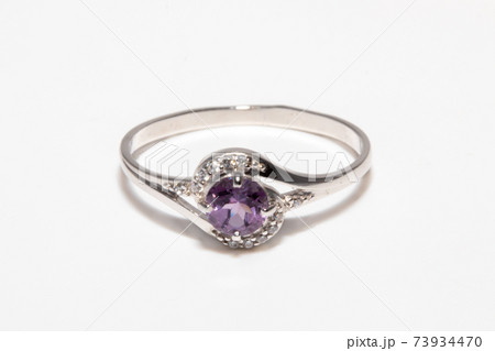 Beautiful silver ring with purple gemstone isolated on white background 73934470