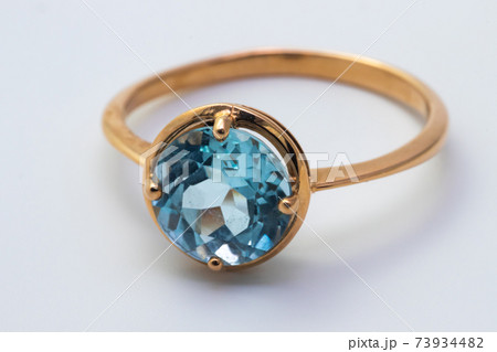 Beautiful old golden ring with blue gemstone isolated on white background 73934482