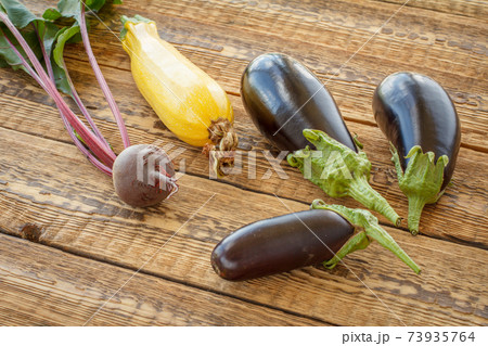 Just picked vegetables on old wooden boards. 73935764
