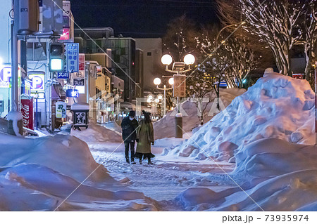 青森市　コロナ禍の大雪　除雪の雪山の繁華街 73935974