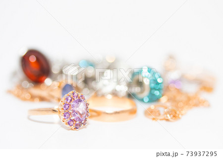 Collection of jewelry with beautiful golden ring with purple stone isolated on white background 73937295