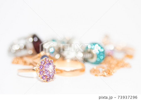 Collection of jewelry with beautiful golden ring with purple stone isolated on white background 73937296