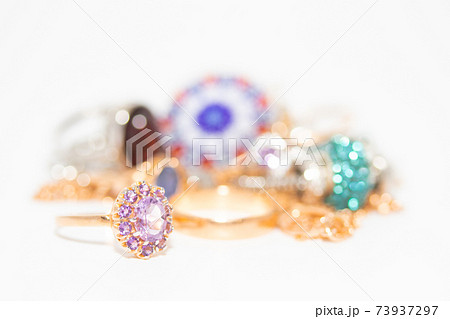 Collection of jewelry with beautiful golden ring with purple stone isolated on white background Collection of jewelry with beautiful golden ring with purple stone isolated on white background 73937297