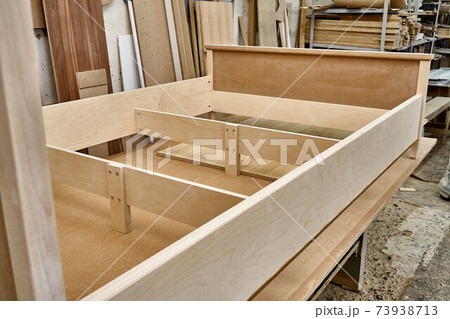 Joinery. Bed building process. Wooden furniture manufacturing process. Furniture manufacture. Close-up Joinery. Bed building process. Wooden furniture manufacturing process. Furniture manufacture. Close-up 73938713