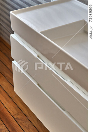 Wall mounted bathroom vanity in luxury bathroom with teak floor. Stylish interior of modern bathroom. Details furniture 73939866