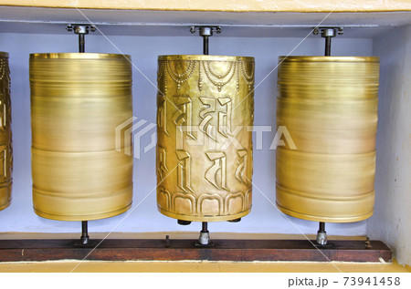 tibetan Buddhist prayer wheels in McLeod Ganj temple, India tibetan Buddhist prayer wheels in McLeod Ganj temple, India 73941458