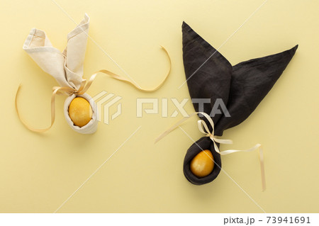 Easter bunnies from napkin and golden painted egg 73941691