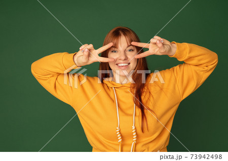 Caucasian woman's portrait isolated on green studio background with copyspace 73942498