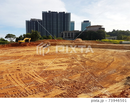 CYBERJAYA, MALAYSIA -JANUARY 8, 2020: Earthworks for the new development area. Heavy machinery doing forest clearing and earthworks to obtain the required level. CYBERJAYA, MALAYSIA -JANUARY 8, 2020: Earthworks for the new development area. Heavy machinery doing forest clearing and earthworks to obtain the required level. 73946501