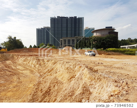 CYBERJAYA, MALAYSIA -JANUARY 8, 2020: Earthworks for the new development area. Heavy machinery doing forest clearing and earthworks to obtain the required level. 73946502