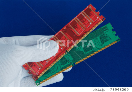 Hand in white glove holds two memory cards. Hand in white glove holds two memory cards. 73948069