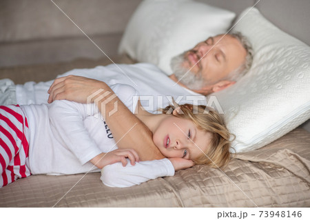 Sleepy kid and sleeping dad hugging him Sleepy kid and sleeping dad hugging him 73948146