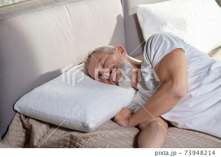Sleeping adult man lying on the bed Sleeping adult man lying on the bed 73948214