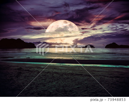 Super moon. Colorful sky with bright full moon over seascape. Super moon. Colorful sky with bright full moon over seascape. 73948853