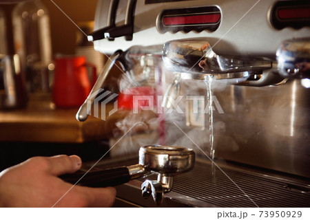 close up barista hand making a cup of coffee close up barista hand making a cup of coffee 73950929