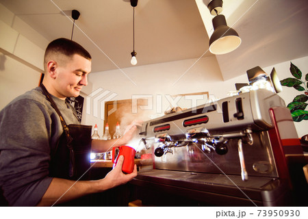 Barista preparing coffee in a coffee shop. Professional coffee making, service and catering concept 73950930
