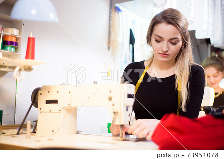 Process of working with sewing machine in an atelier. 73951078