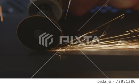 Steel cutter with sparks while cutting steel bar 73951286