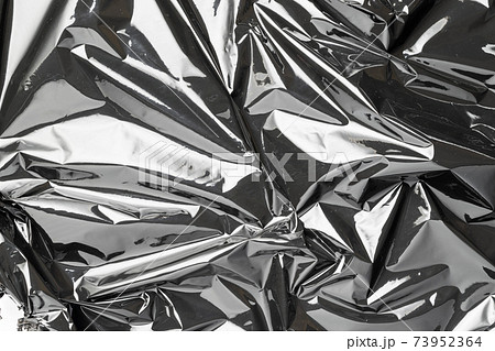 Black background. Black shiny film bag pattern. Wrap transparent dark cellophane texture. Creative crumpled background. Black background. Black shiny film bag pattern. Wrap transparent dark cellophane texture. Creative crumpled background. 73952364