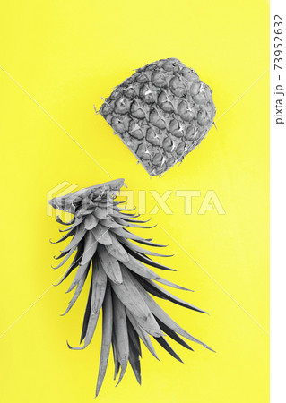 Pineapple fruit half cut on yellow background Pineapple fruit half cut on yellow background 73952632