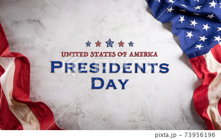 Happy presidents day concept with flag of the United States on old stone background. Happy presidents day concept with flag of the United States on old stone background. 73956196