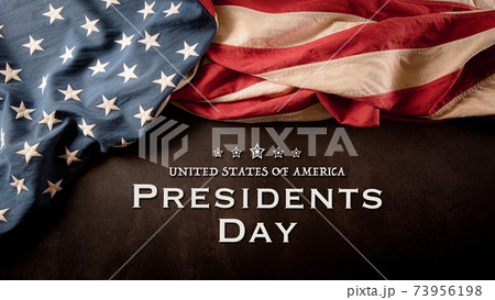 Happy presidents day concept with vintage flag of the United States on dark stone background. 73956198