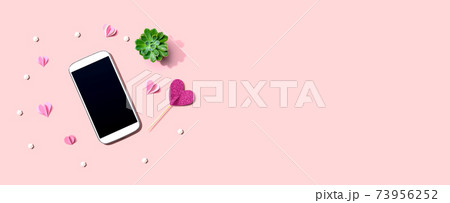 Smartphone with hearts and a succulent Smartphone with hearts and a succulent 73956252