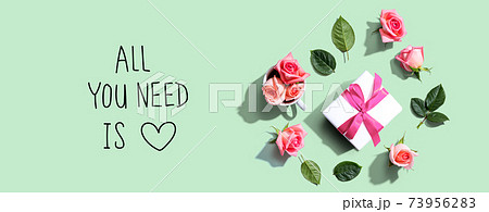 All you need is love message with a gift box and roses All you need is love message with a gift box and roses 73956283